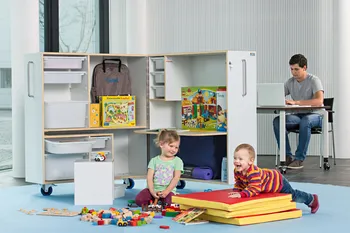 Playing children and student sitting at desk