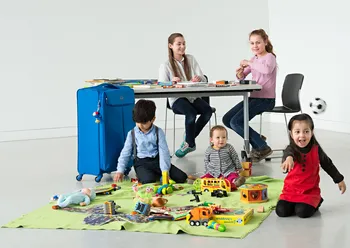 Two girls and and three younger children are playing.